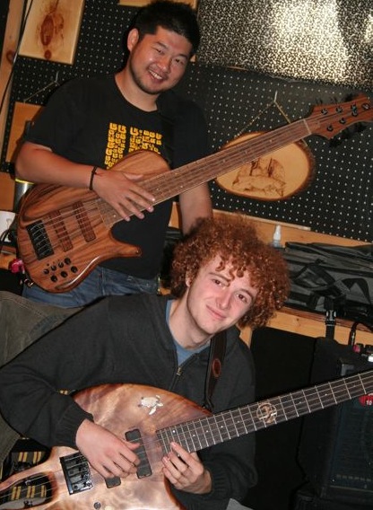 Two students smiling with their basses
