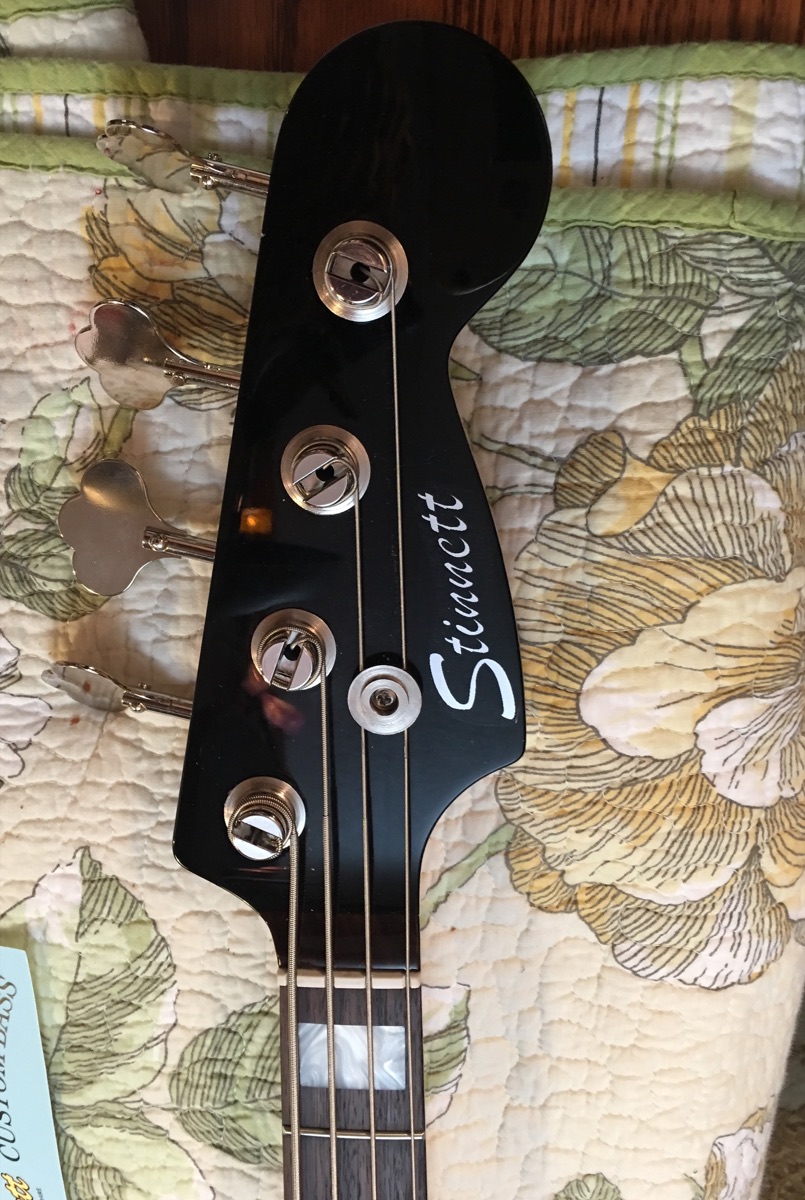 Headstock of a Stinnett custom bass with the Stinnett logo