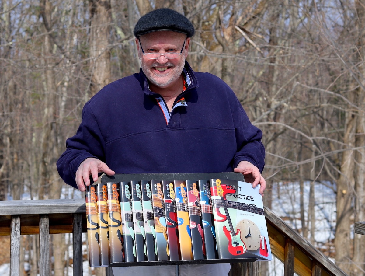 Jim Stinnett holding the twelve Daily Practice For Bass books